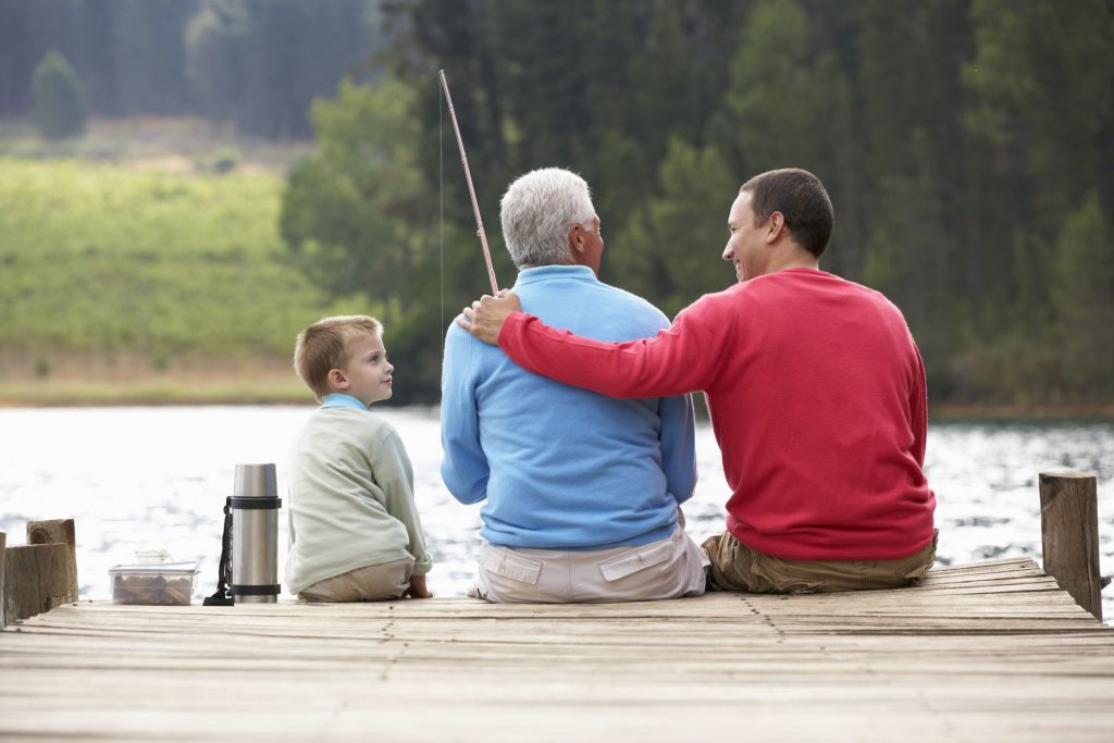 a small boy, his father and grandfather fishing