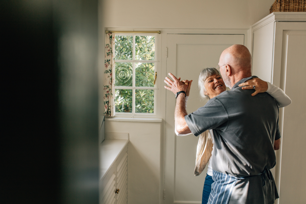 Happy Elderly Couple Dancing Together Holding Each Other