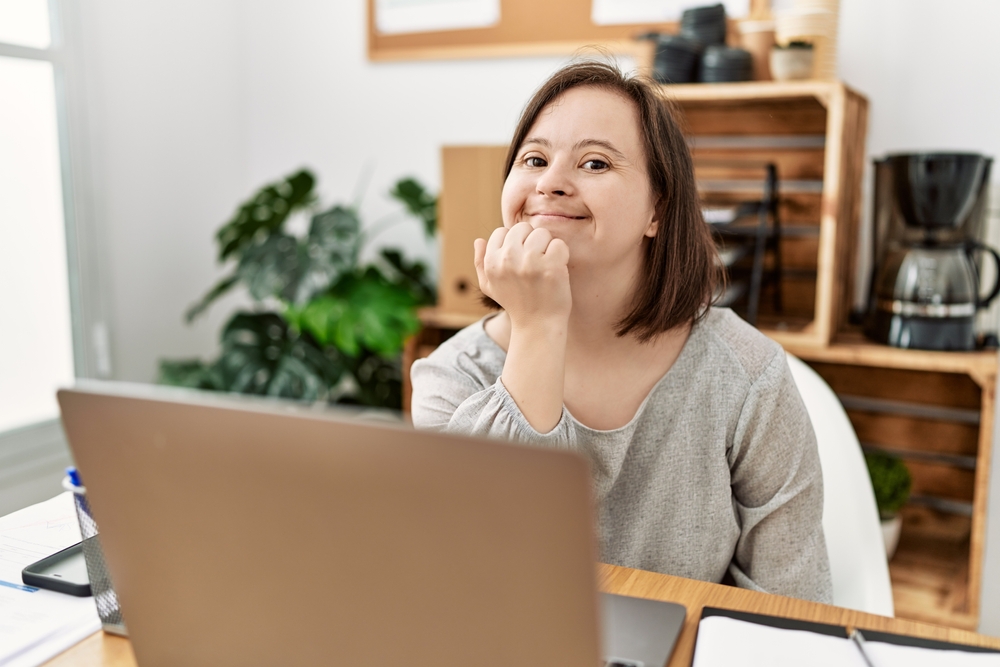 Brunette Woman With Down Syndrome Working At Business Office