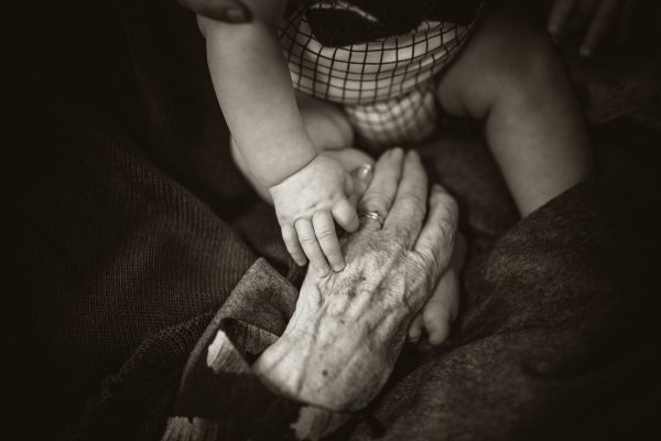 old hand holding a baby hand