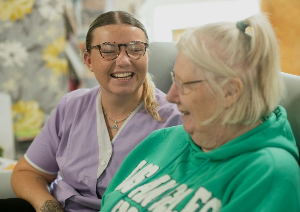 Carer and woman smiling