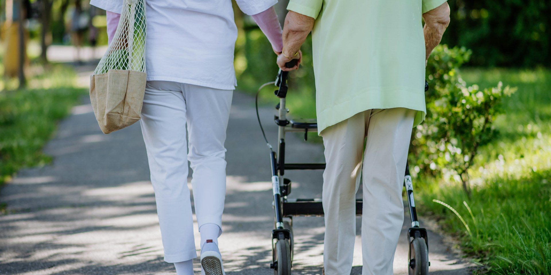 Elderly mother and daughter walking together